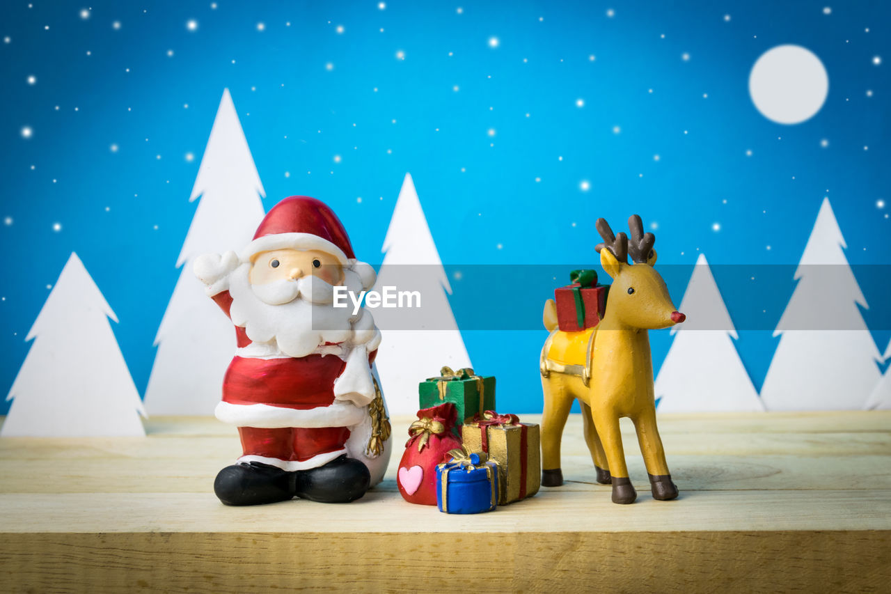 TOYS ON TABLE AGAINST BLUE WALL