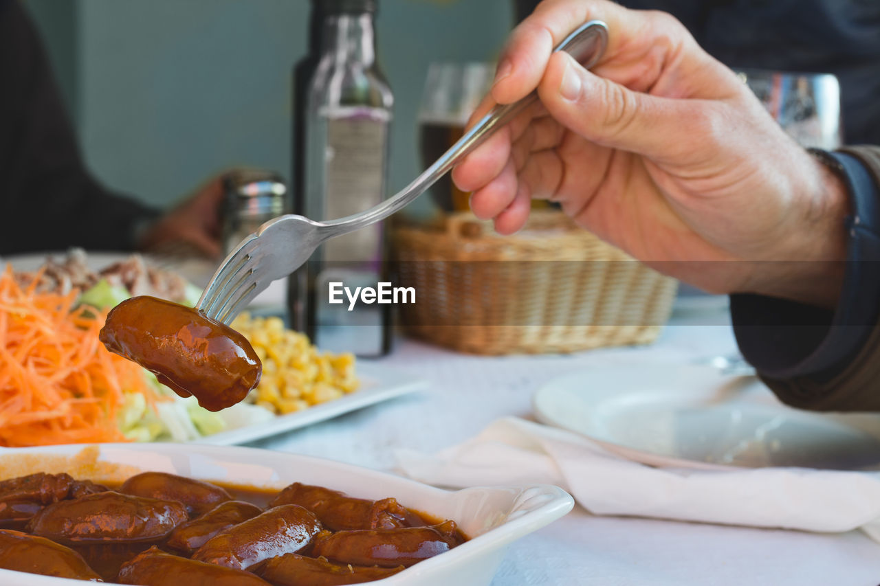 Close-up of man eating meal served in plate