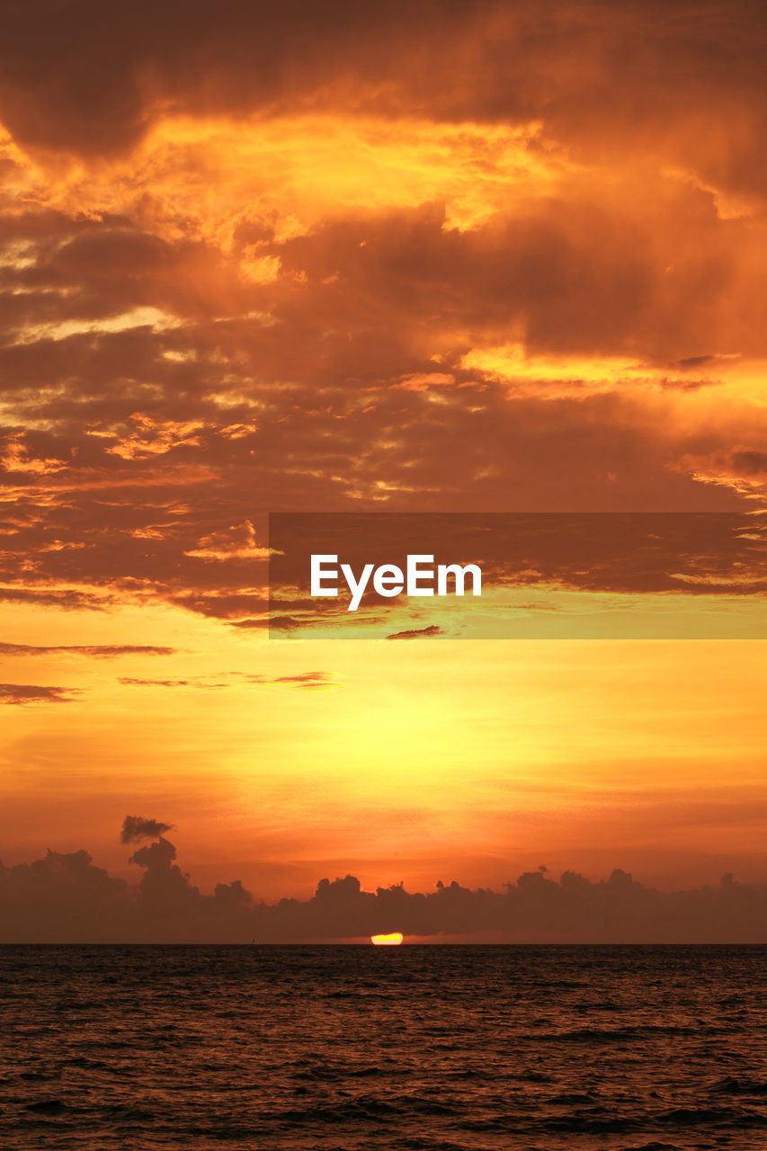 Scenic view of sea against romantic sky at sunset