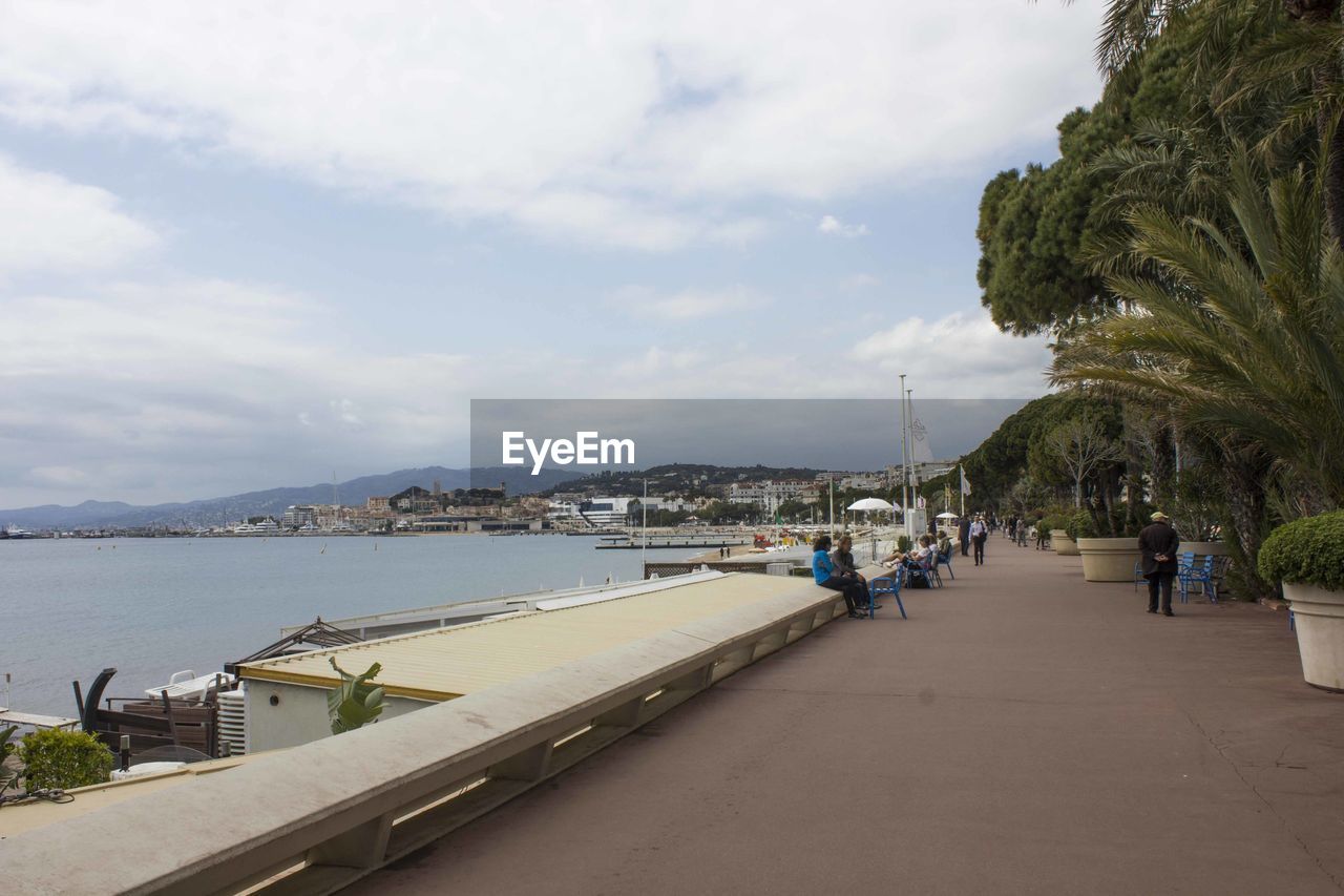 Scenic view of sea by city against sky