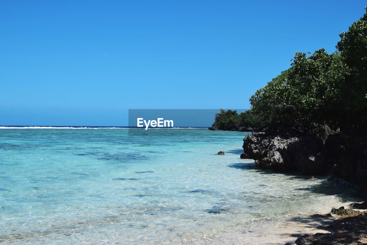 Scenic view of sea against clear blue sky