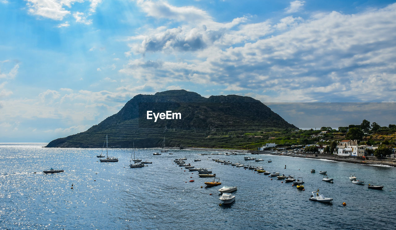 SAILBOATS MOORED IN BAY