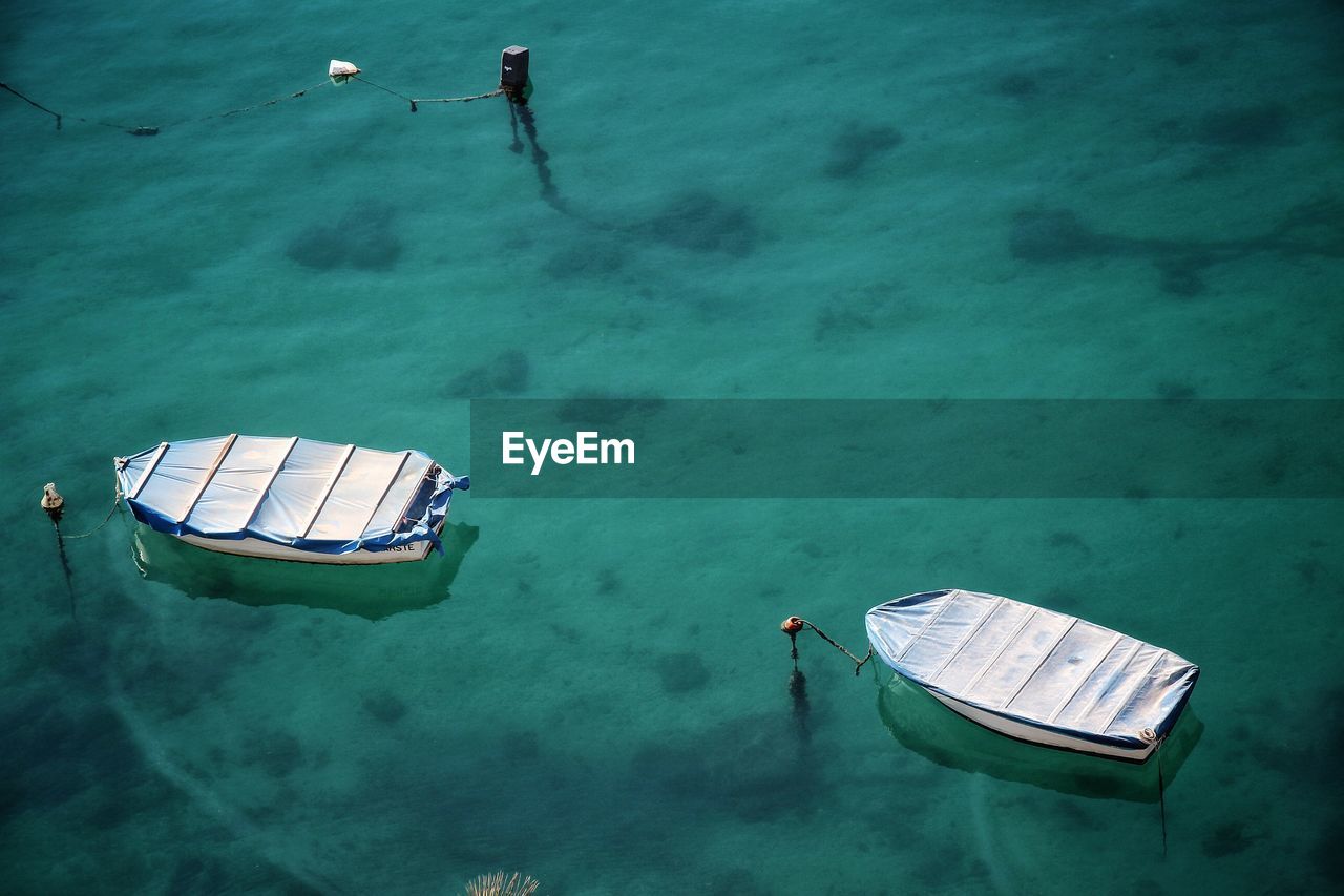 High angle view of covered boats moored on sea