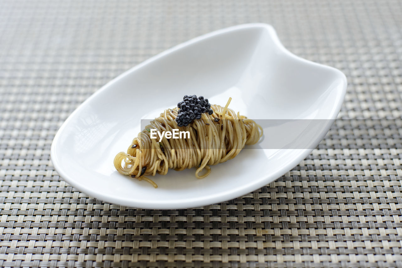 Close-up of pasta with caviar in plate