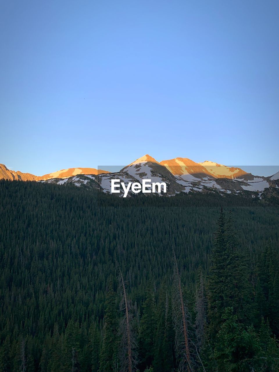 Scenic view of mountains against clear blue sky