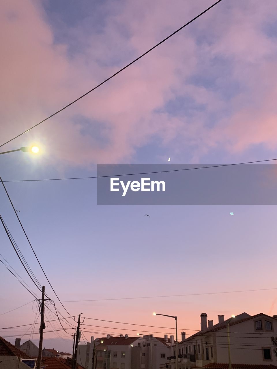 sky, architecture, cable, electricity, cloud, nature, low angle view, built structure, no people, evening, building exterior, technology, mast, sunset, lighting, city, line, outdoors, light, transportation, power line, power supply, electrical supply, dusk, overhead power line, power generation, sunlight