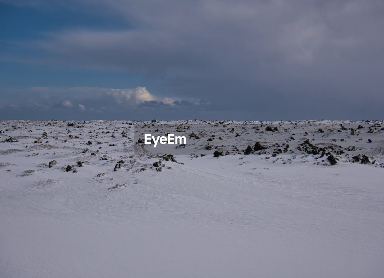 SNOW COVERED LAND AGAINST SKY