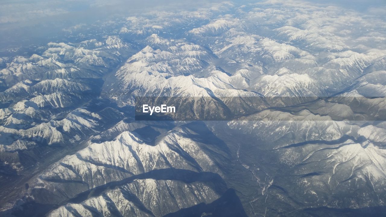 AERIAL VIEW OF SNOW COVERED LAND