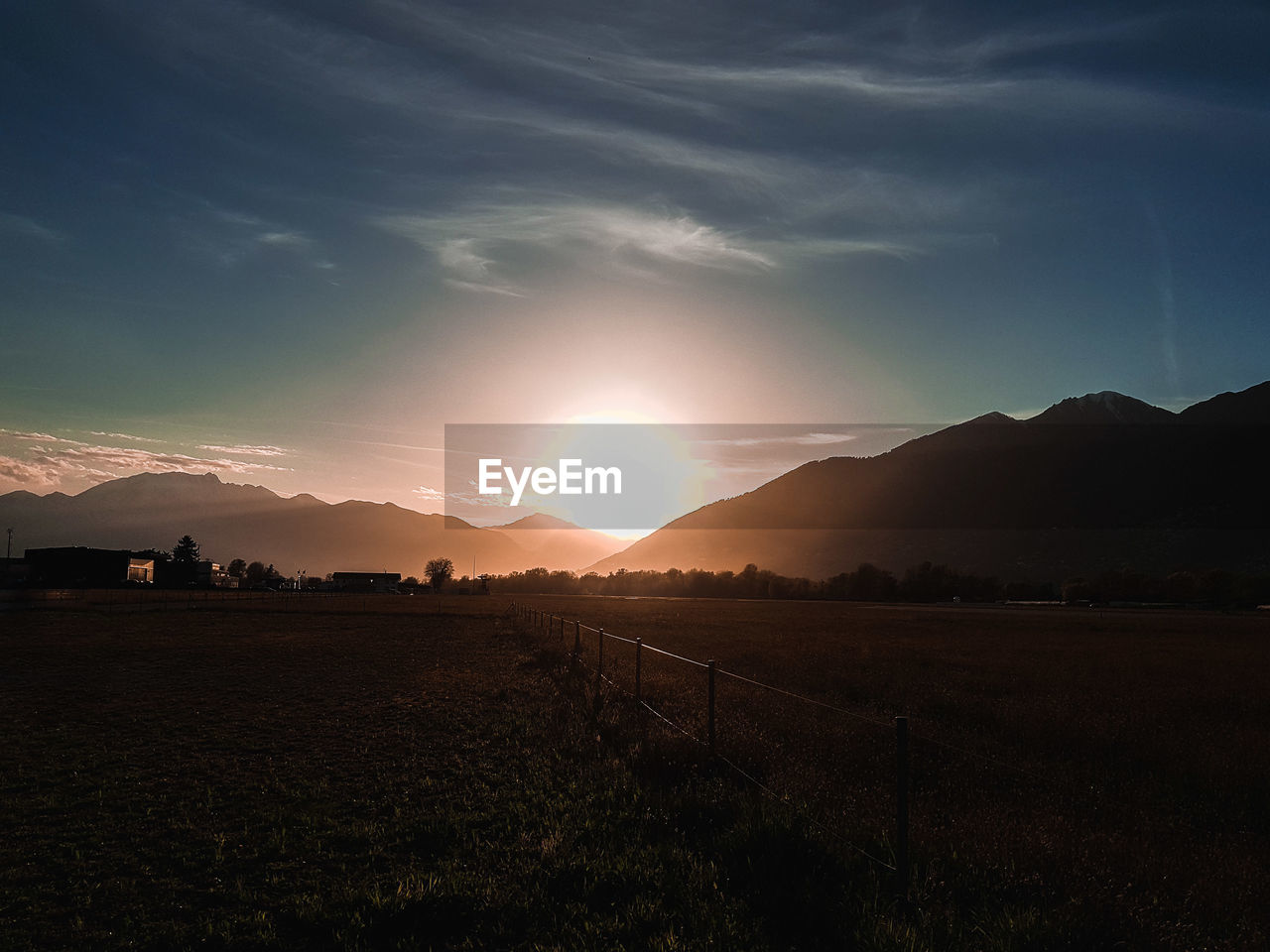 Scenic view of field against sky during sunset