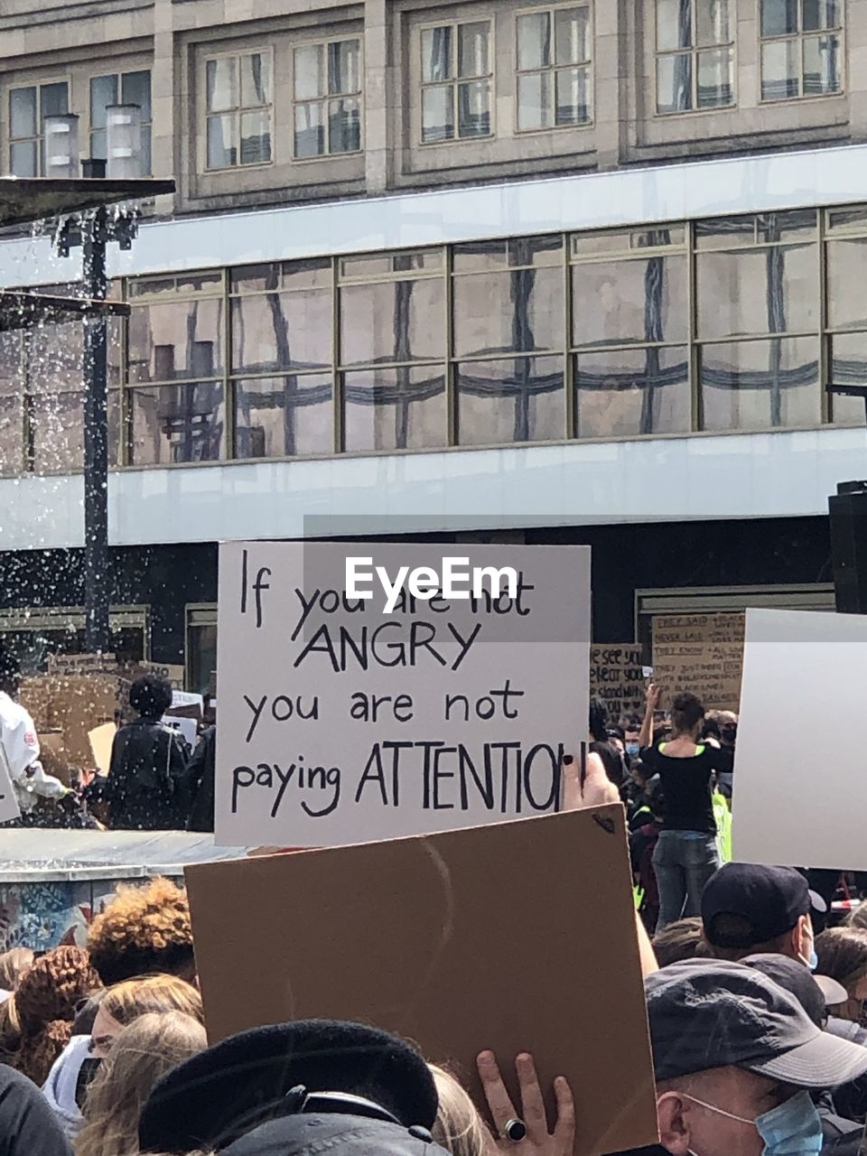 PEOPLE ON STREET IN FRONT OF OFFICE BUILDING