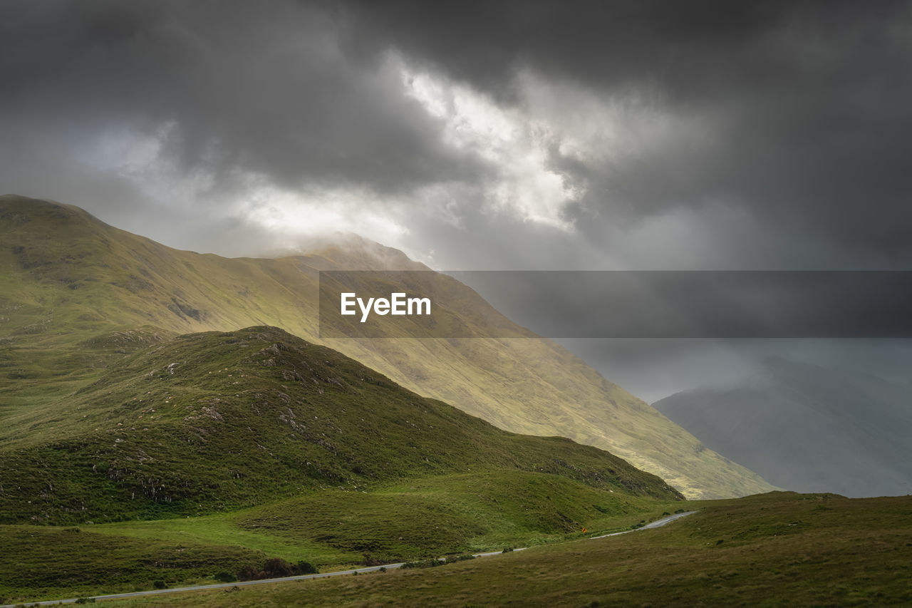 Doolough valley, glenummera and glencullin mountain ranges illuminated by sunlight, ireland