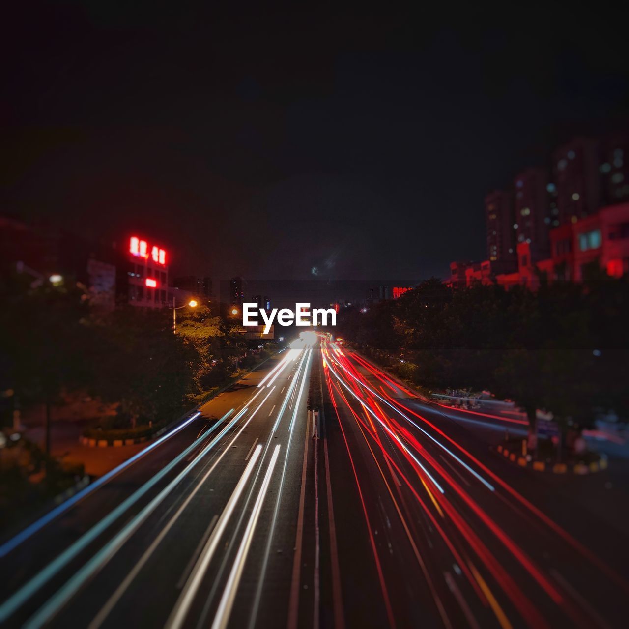 High angle view of light trails on highway at night