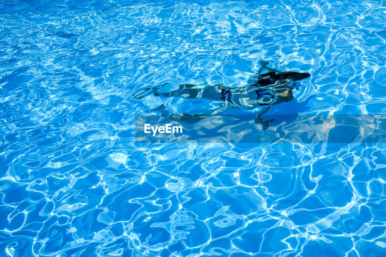High angle view of woman swimming in pool