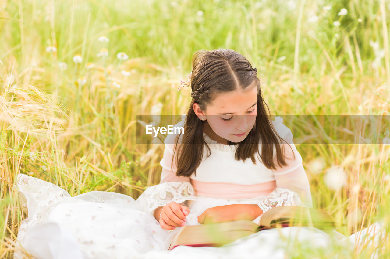portrait of young woman sitting on grass