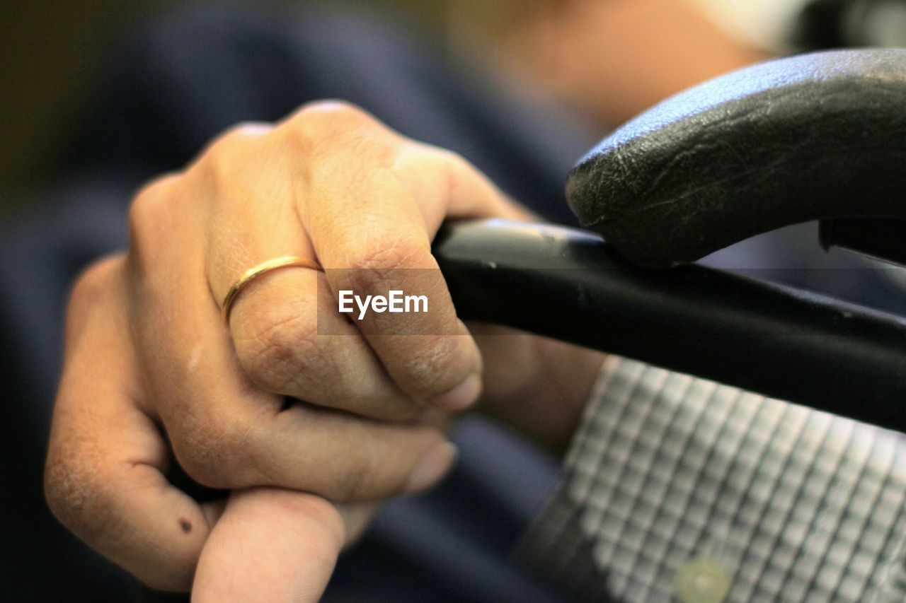 hand, close-up, finger, arm, limb, one person, adult, focus on foreground, holding, men, indoors, human leg