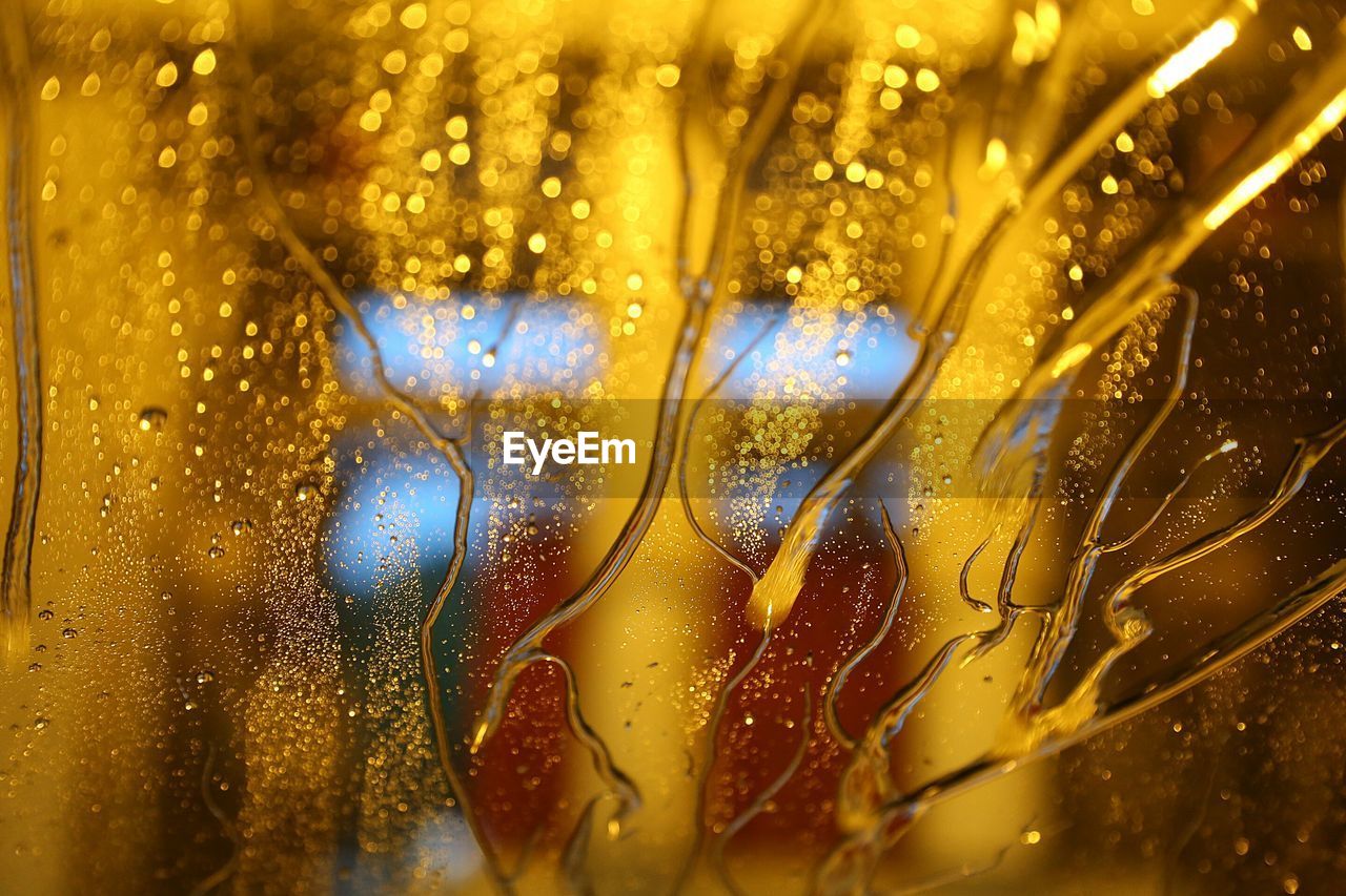 Close-up of wet car window at night