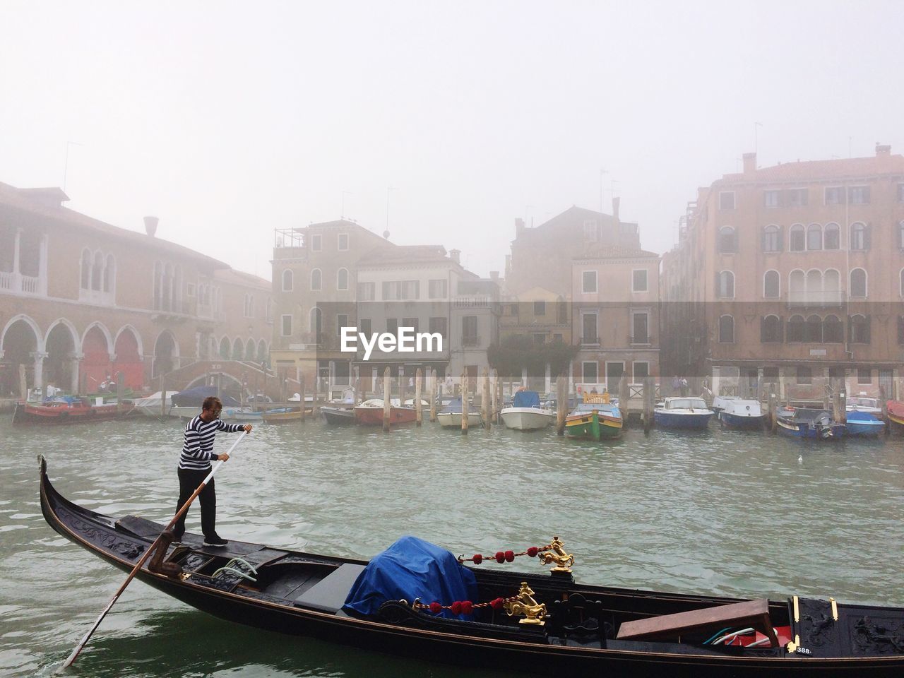 BOATS IN CANAL IN CITY