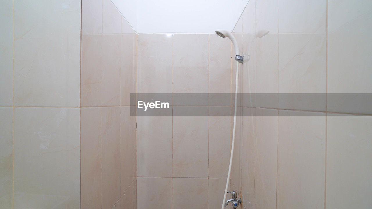 bathroom, shower, indoors, room, floor, domestic bathroom, domestic room, tile, plumbing fixture, home, flooring, wall - building feature, no people, hygiene, home interior, white, copy space
