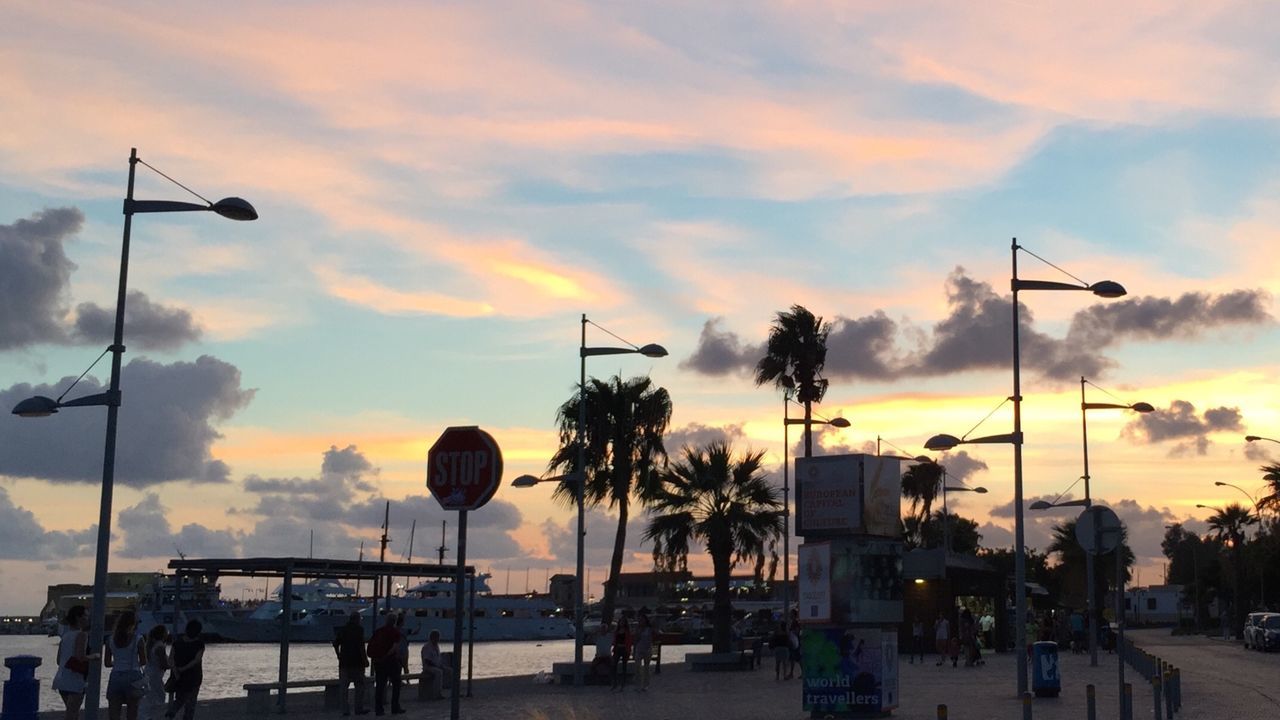 STREET LIGHT AGAINST CLOUDY SKY AT SUNSET