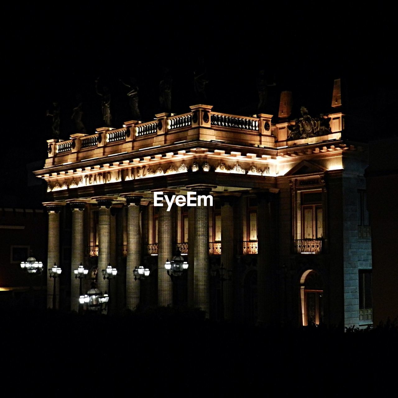 VIEW OF ILLUMINATED BUILDING AT NIGHT