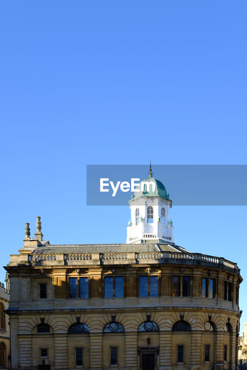 low angle view of historic building against clear blue sky