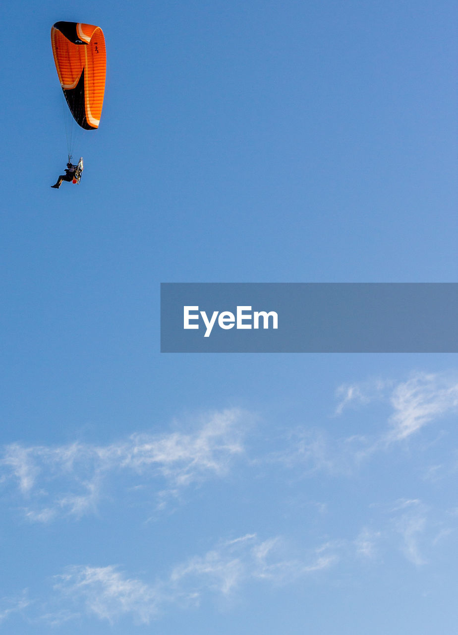 LOW ANGLE VIEW OF PERSON PARAGLIDING IN SKY