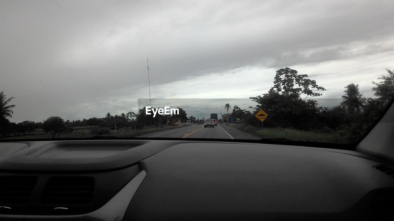 VIEW OF ROAD AGAINST CLOUDY SKY