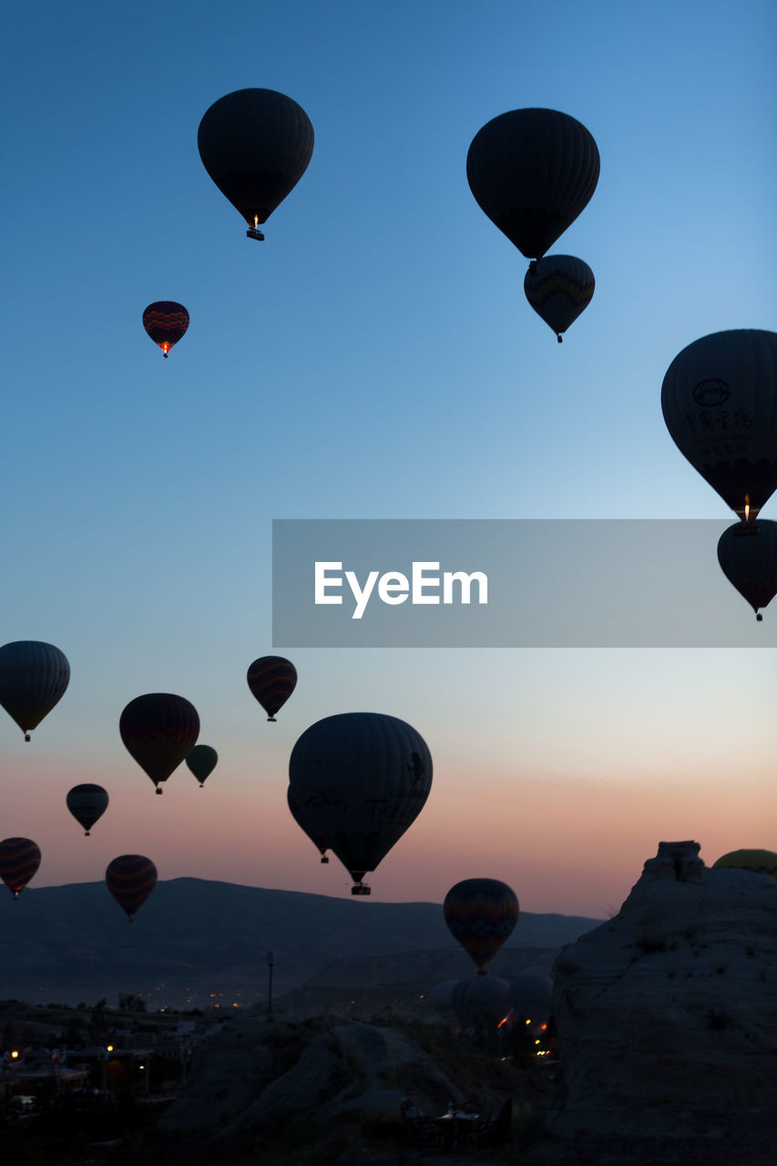 LOW ANGLE VIEW OF HOT AIR BALLOONS FLYING AGAINST SKY
