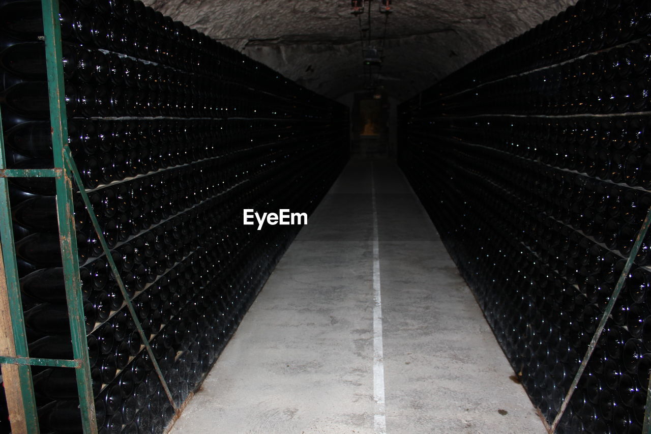 Wine bottles on rack at winery