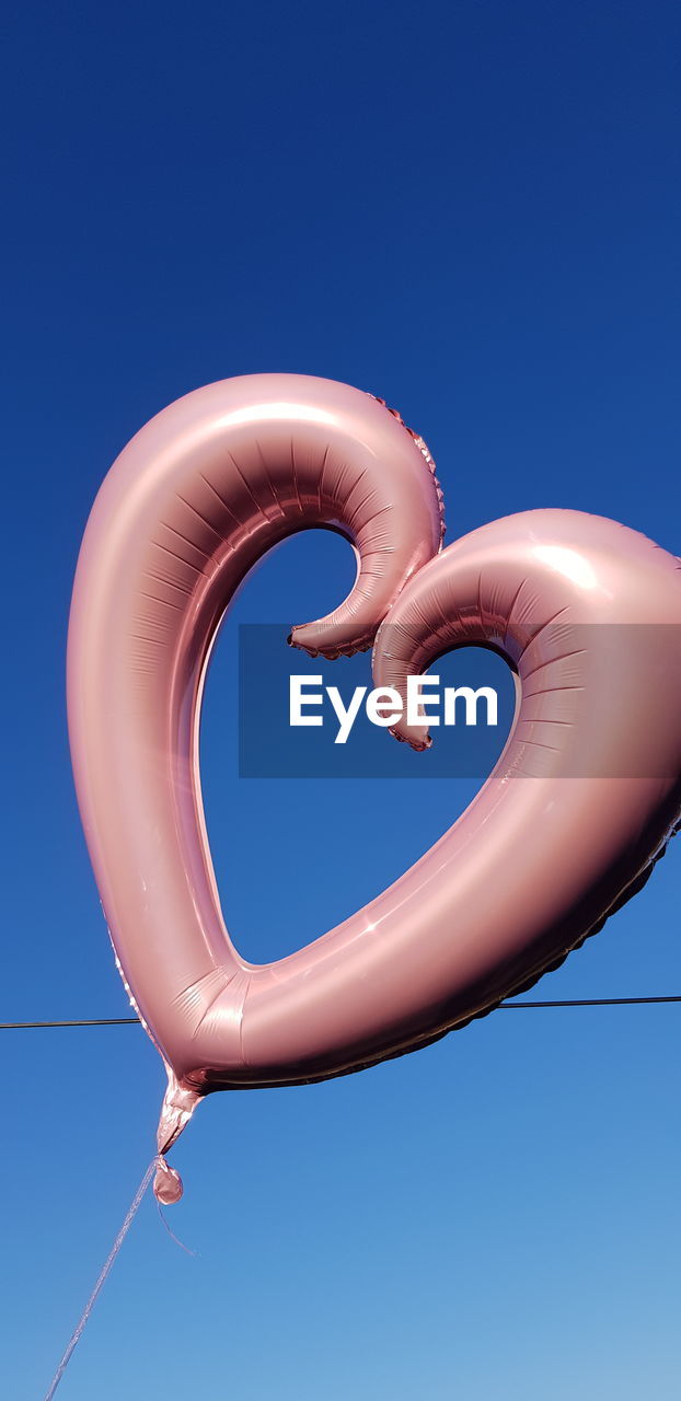 LOW ANGLE VIEW OF BALLOONS AGAINST SKY