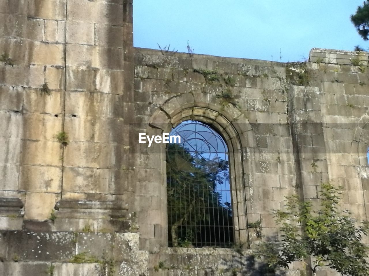 BUILT STRUCTURE AGAINST CLEAR BLUE SKY AND TREES