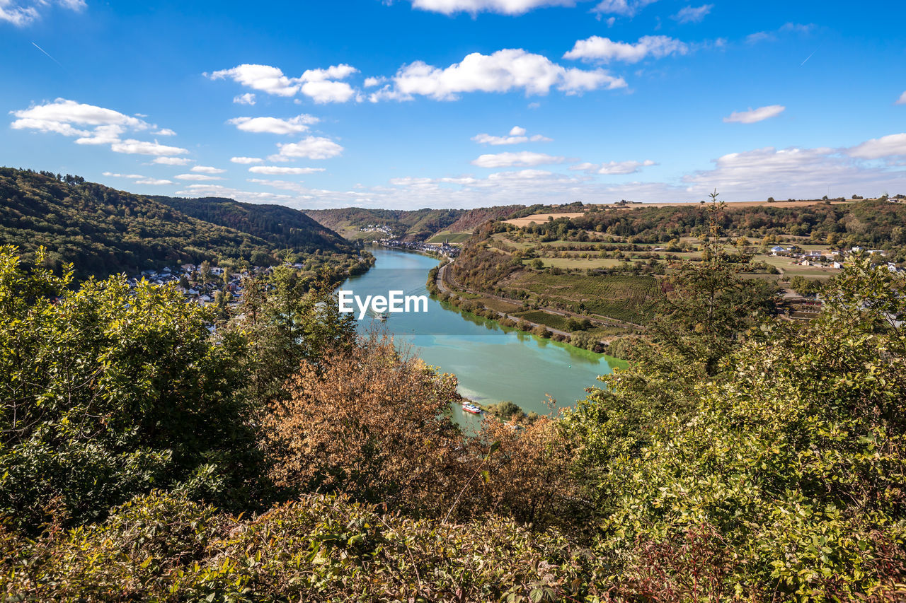 HIGH ANGLE VIEW OF RIVER AMIDST PLANTS AGAINST SKY