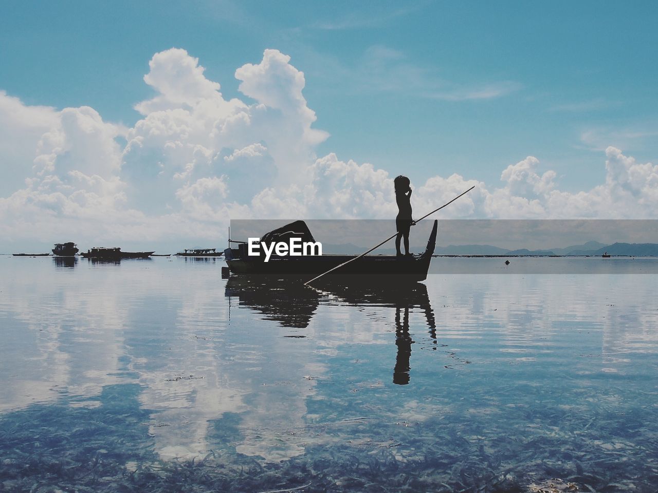 Silhouette of a child on fishing boat