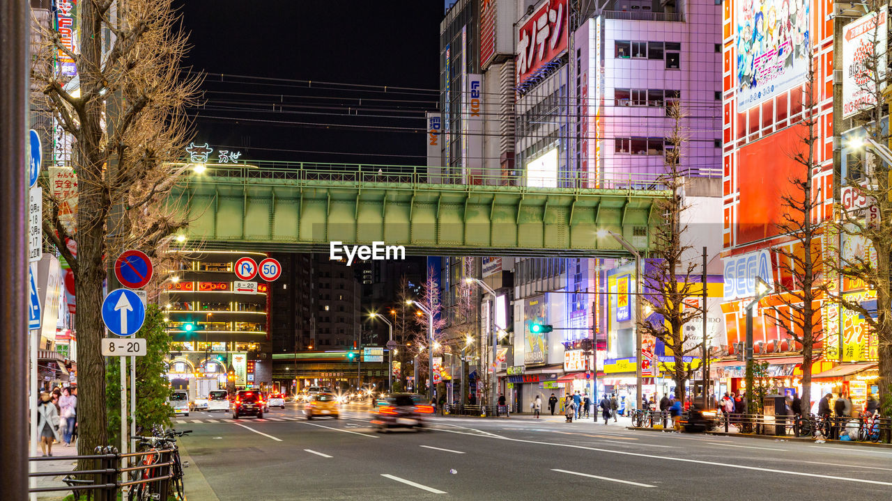 View of city street and buildings at night