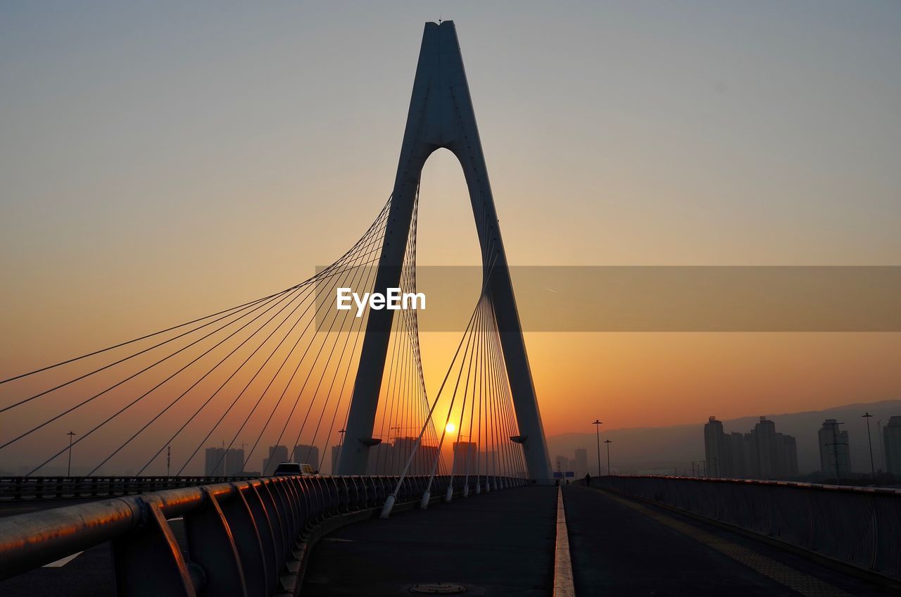 LOW ANGLE VIEW OF SUSPENSION BRIDGE AGAINST SKY