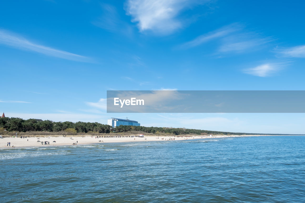 SCENIC VIEW OF BEACH AGAINST BLUE SKY