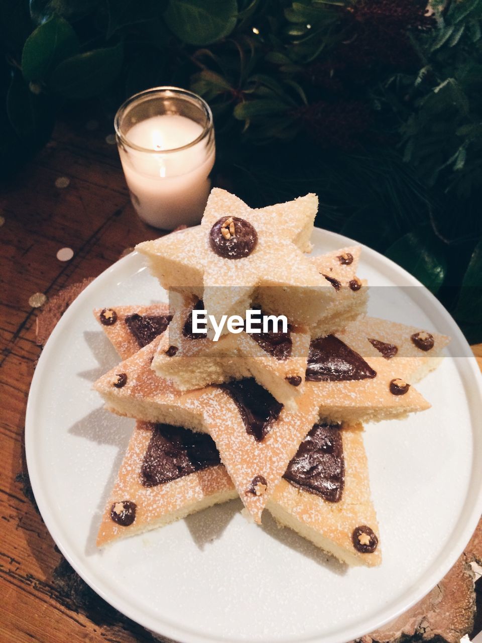 High angle view of dessert by christmas tree on table