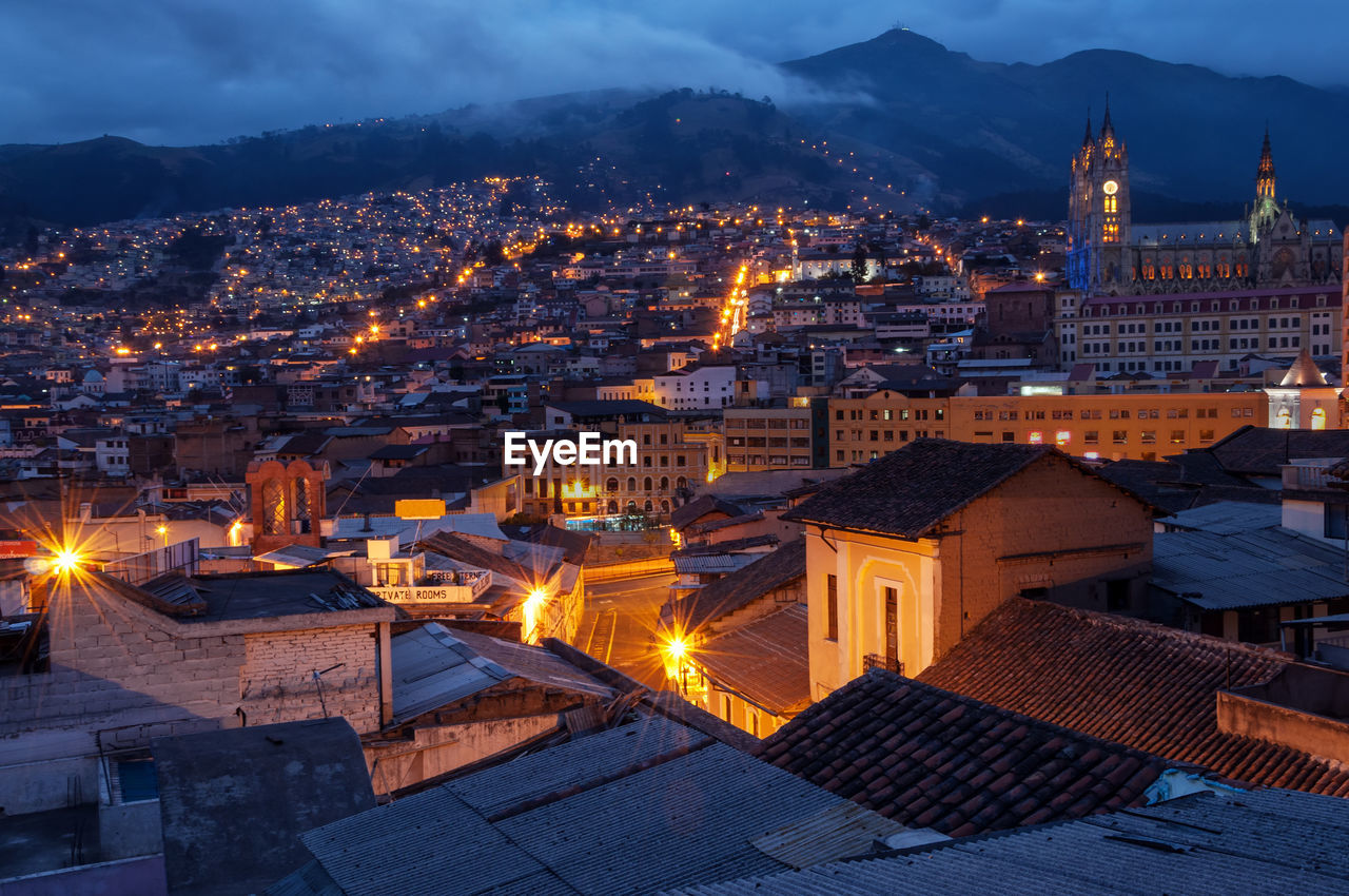 Cityscape by mountains at dusk