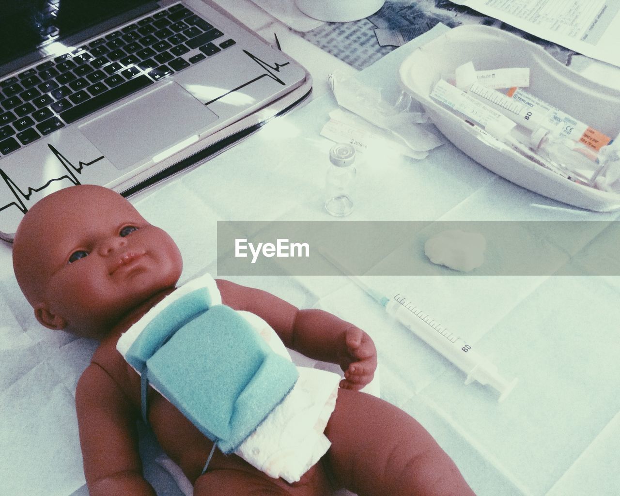 High angle view of doll with medical equipment on table at medical school