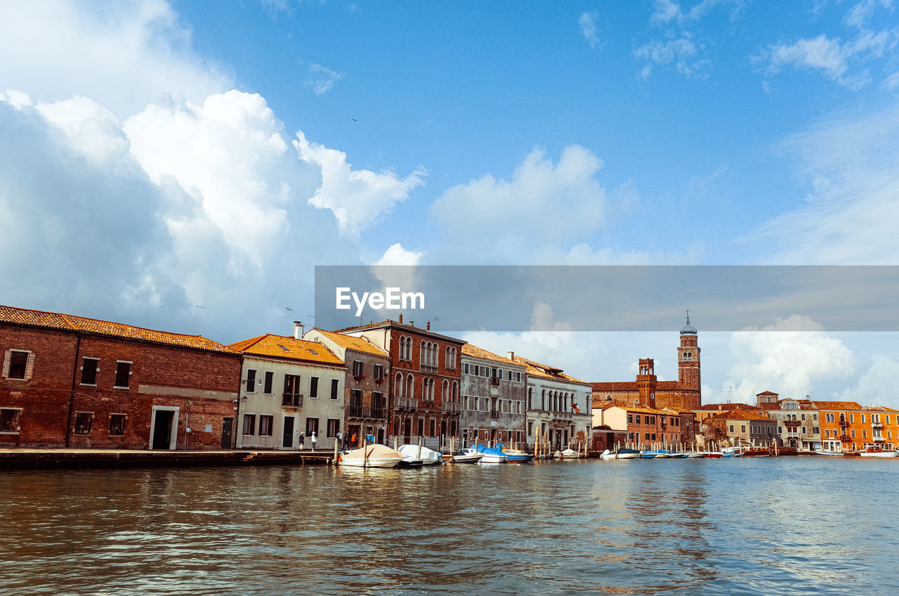 View of sailboat in venice against cloudy sky