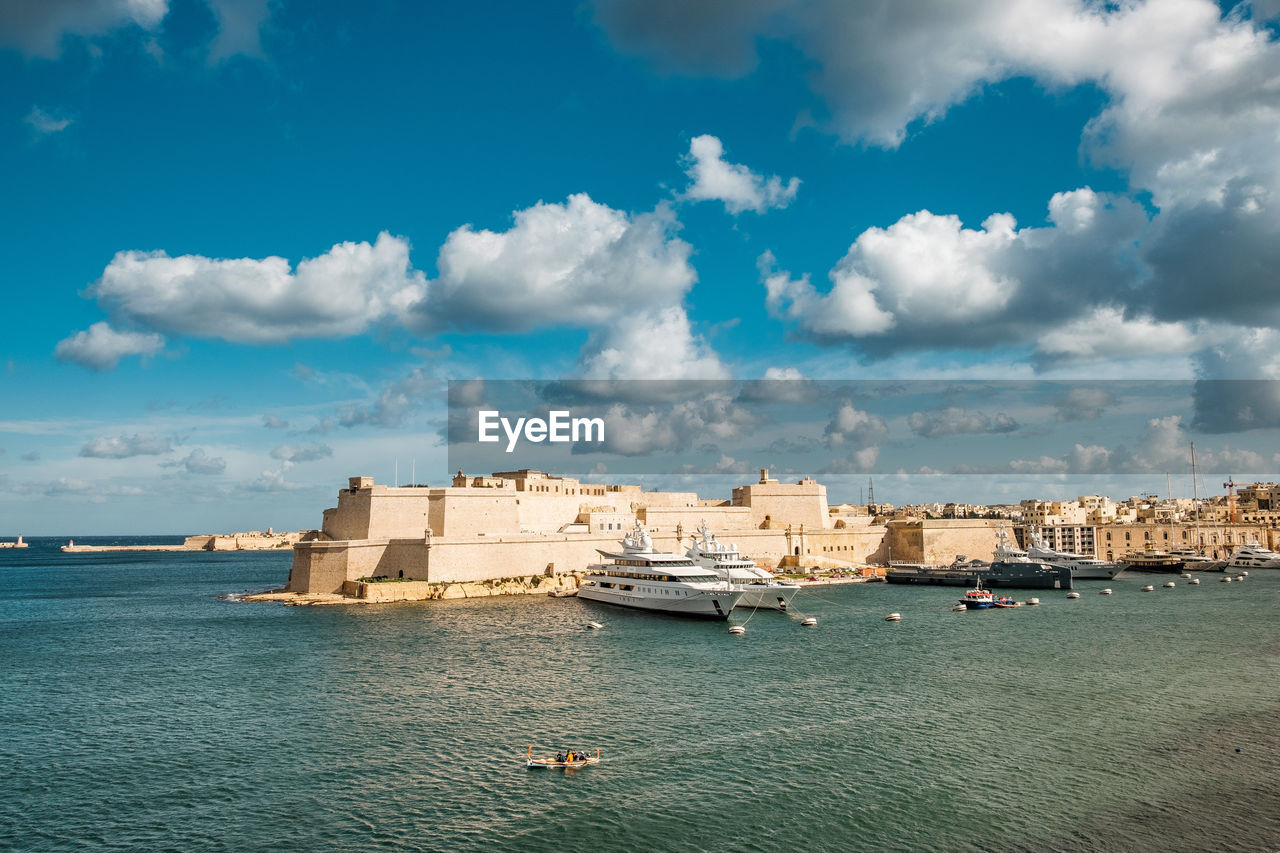 View of the harbor entrance of valletta, blue sky with a few clouds and the mediterranean sea