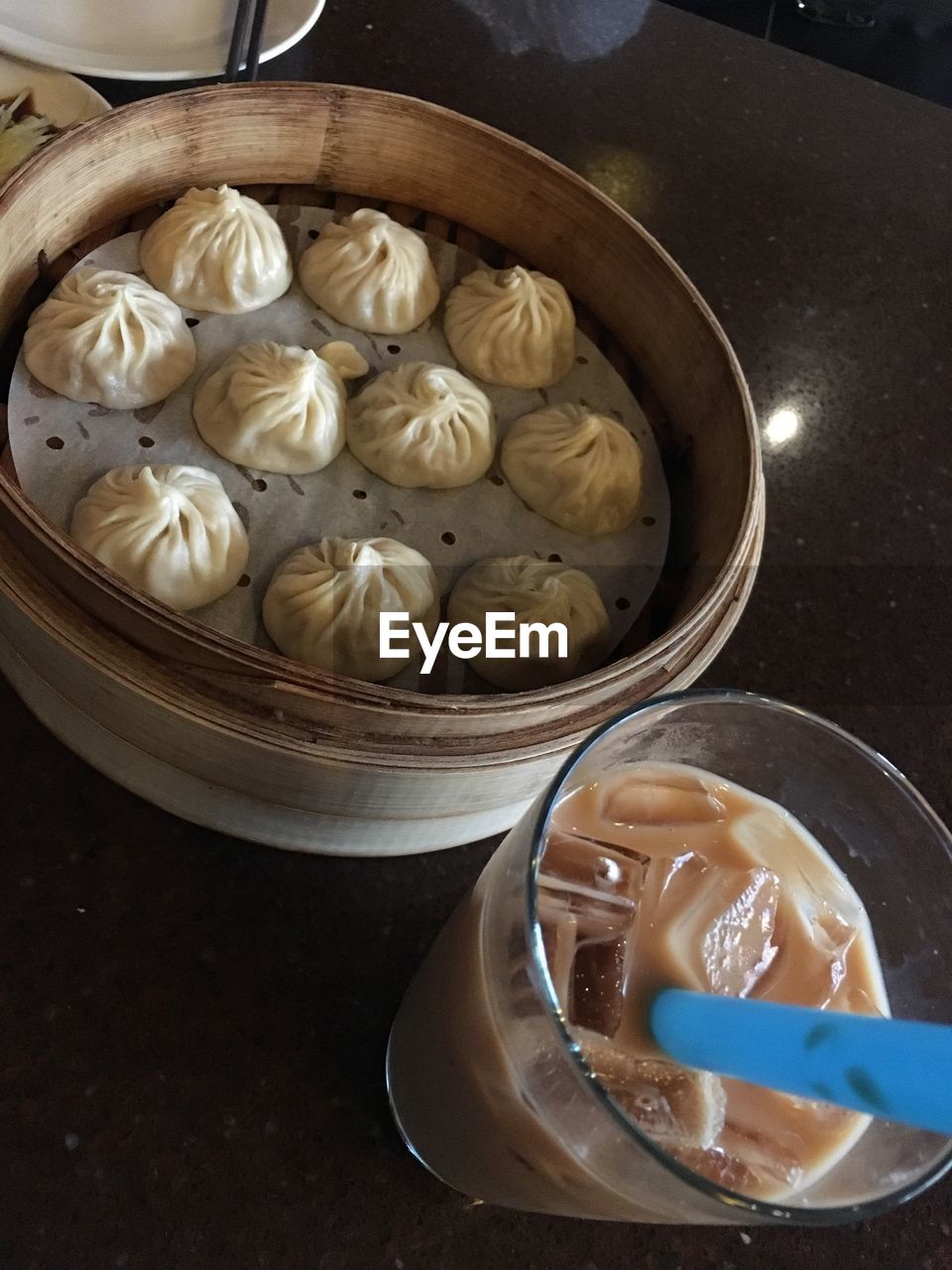 High angle view of dumplings and cold coffee on table