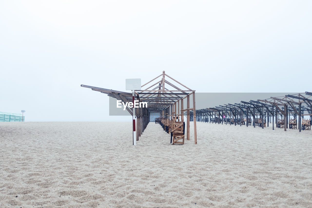 Built structures on beach against clear sky