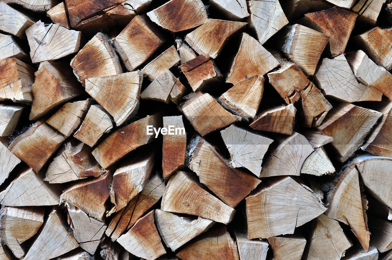 Natural wooden background, chopped firewood. firewood stacked for winter. pile of wood logs
