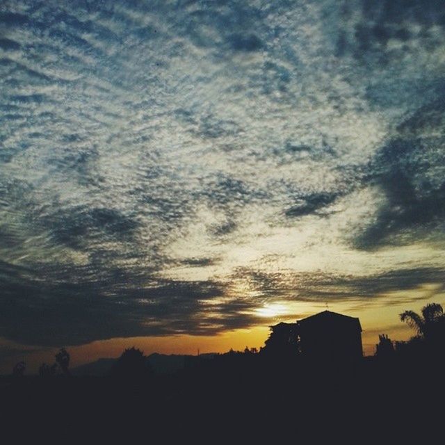 SCENIC VIEW OF LANDSCAPE AGAINST CLOUDY SKY AT SUNSET