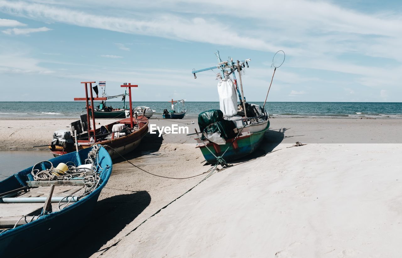 Many fishing boats are parked on the beach.