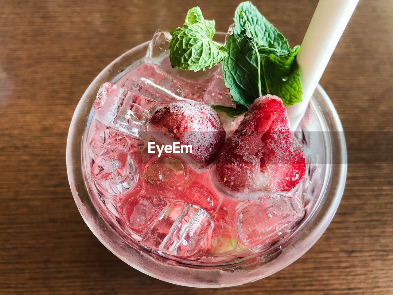 High angle view of strawberry soda in glass on table