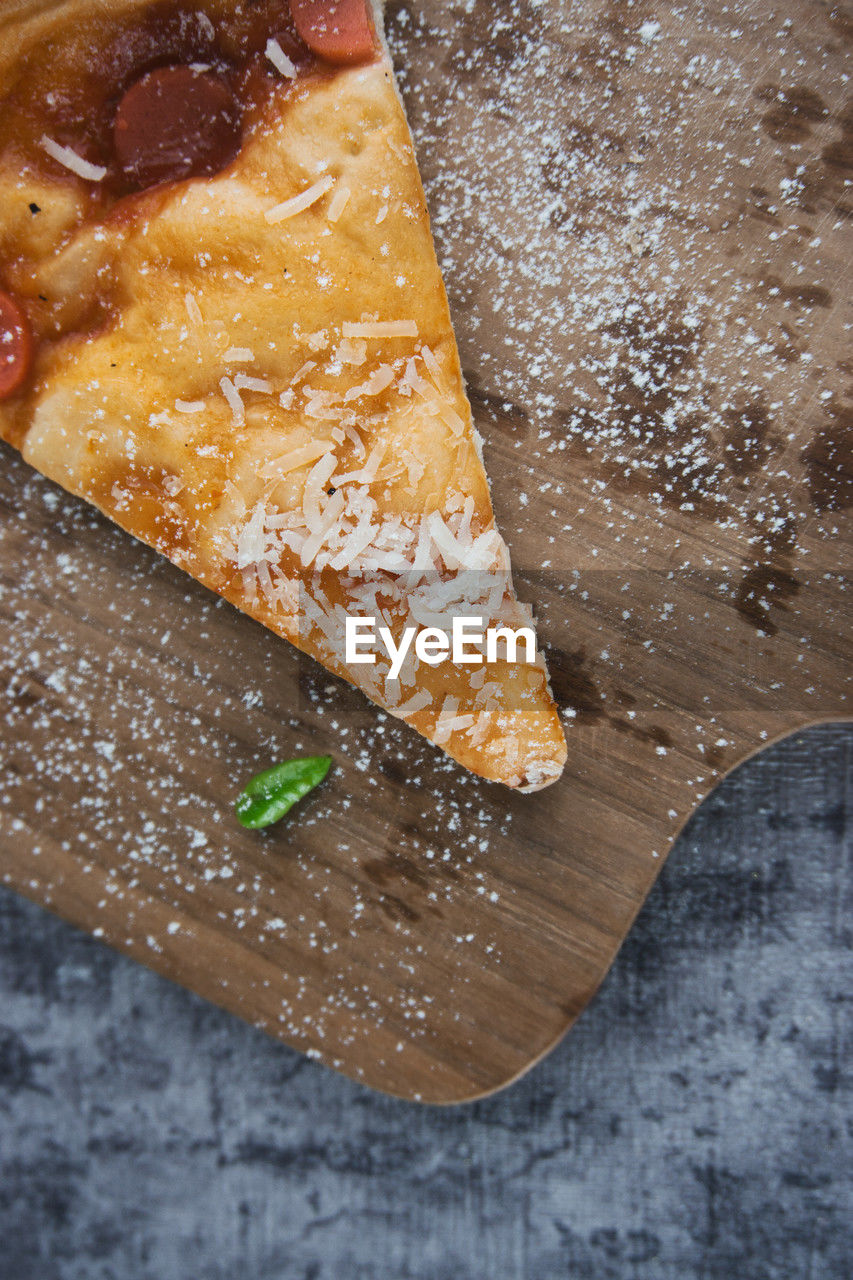 food, food and drink, freshness, high angle view, dish, indoors, still life, dessert, no people, wood, baked, sweet food, slice, close-up, fast food, table, produce, cutting board, dough, cuisine, bread, breakfast, flour