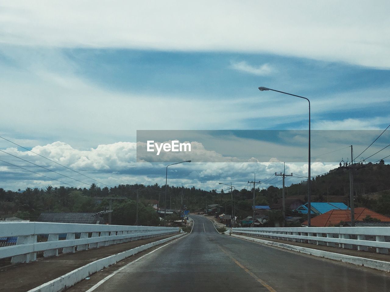 VIEW OF ROAD AGAINST CLOUDY SKY