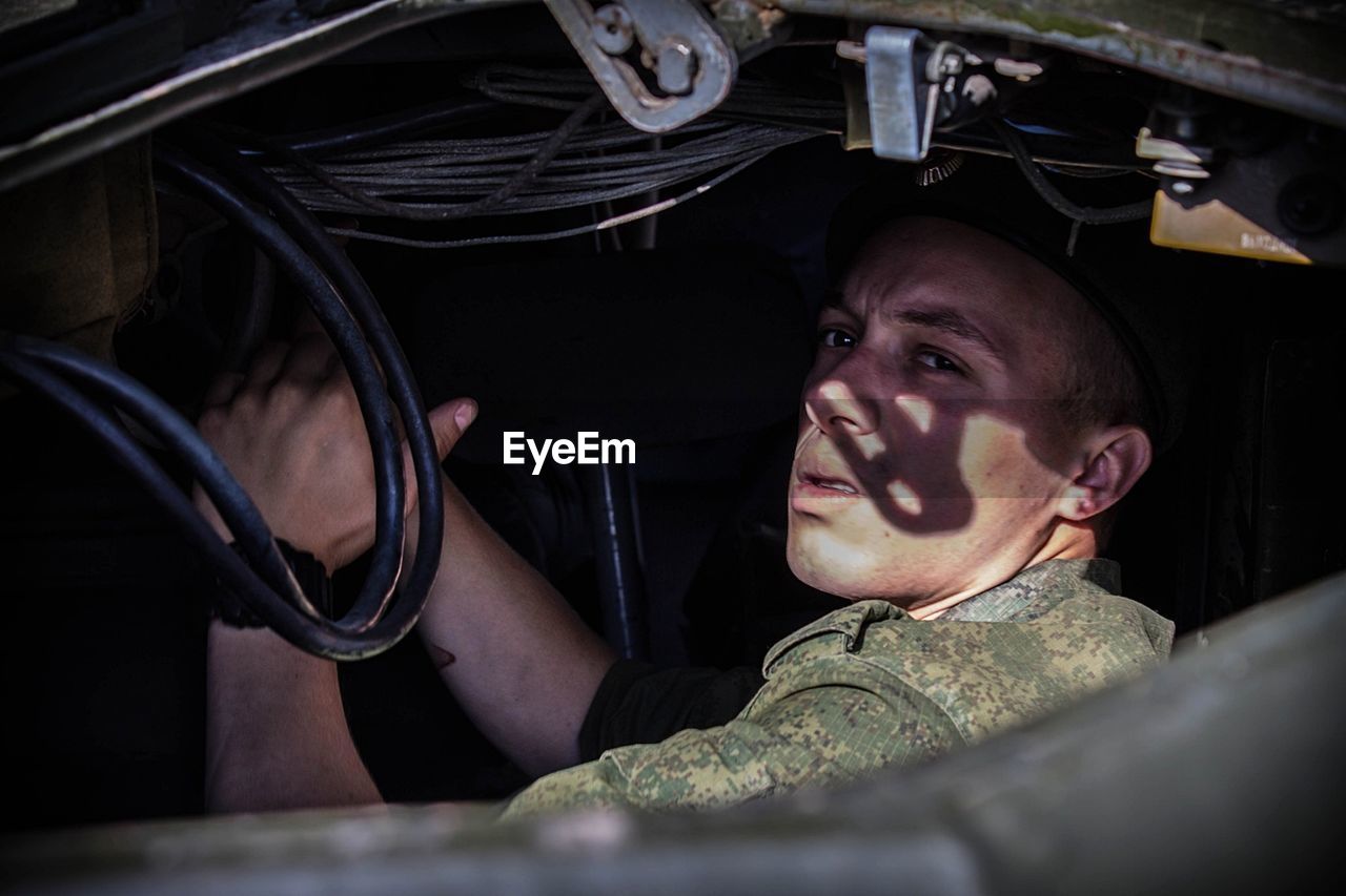 Soldier sitting in military vehicle